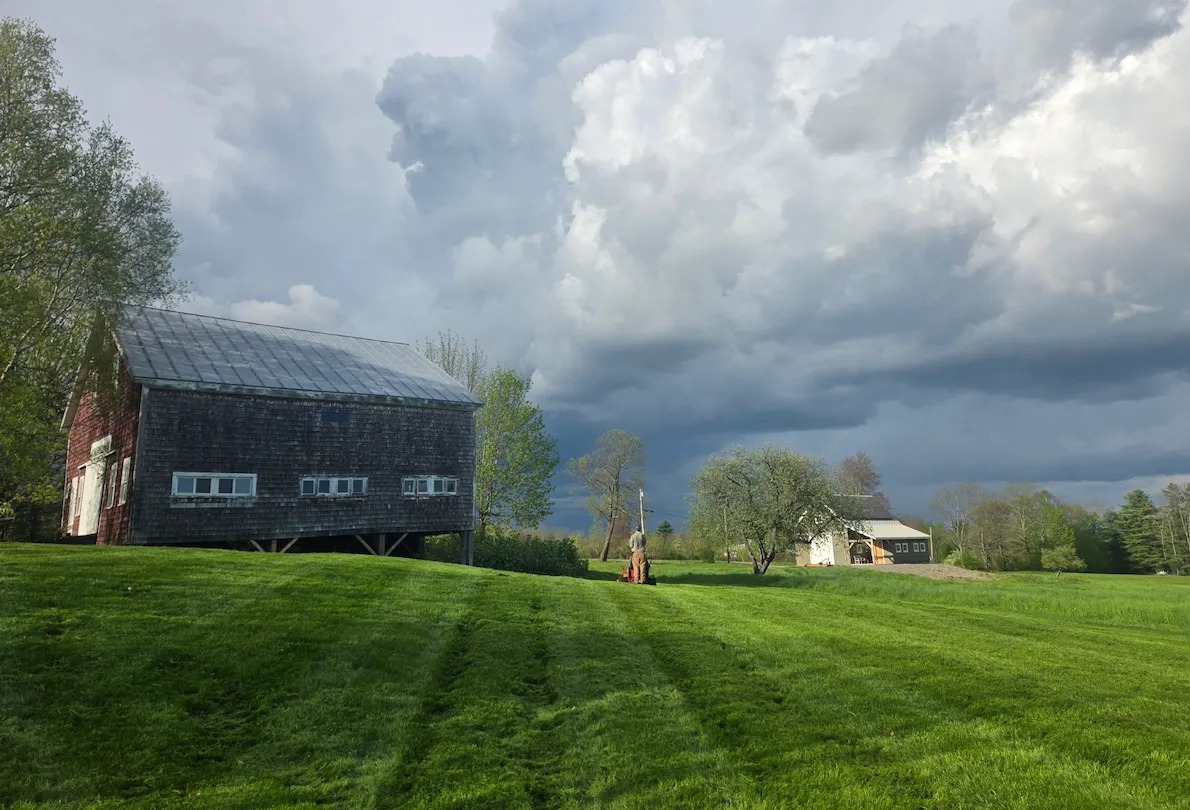 mowed lawn with barn in background