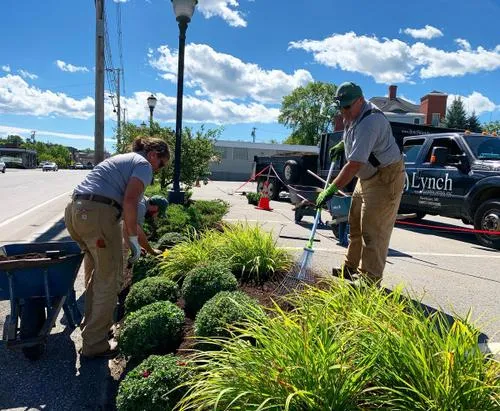 Landscapers adding mulch to a commercial property